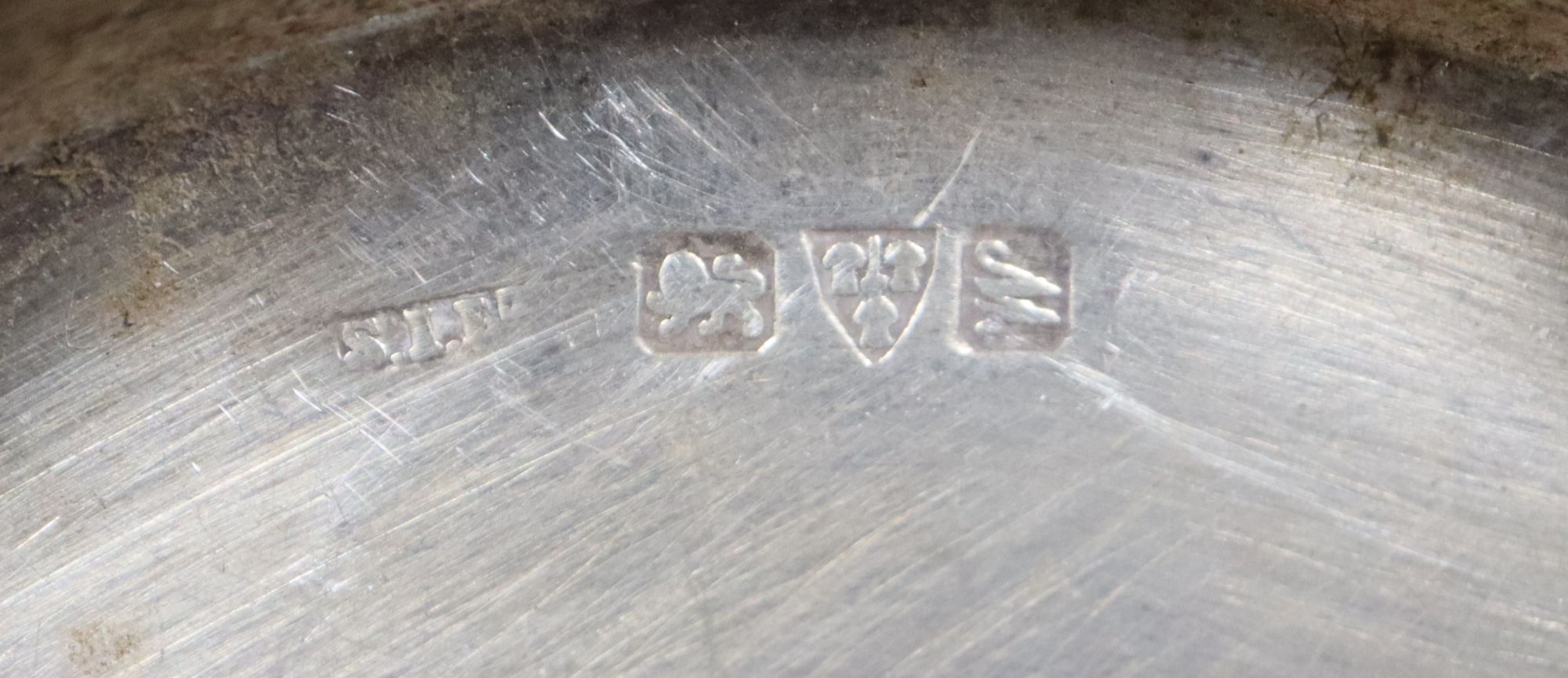 An Edwardian embossed silver sugar caster, 21.2cm, a small Georgian caster, a silver mustard and two circular pin dishes,
